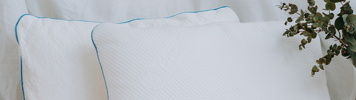 blue piped pillows on bed